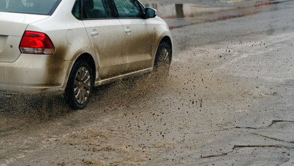 Splashing dirty water from a moving car