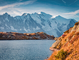 Naklejka premium Beautiful autumn scenery. Majestic autumn view of Cheserys lake with Mount Blanc on background, Chamonix location. Great outdoor scene of Vallon de Berard Nature Preserve, Alps, France.