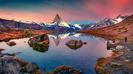 Photographer takes picture of Stellisee lake with Matterhorn peak on background. Unbelievable ...