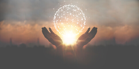 Silhouette a man use hand holding line circle online social media networking, sunset backgrounds, futuristic technology concept.