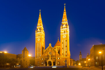 Obraz premium Illustration of view on Cathedral in night light of Szeged in Hungary.