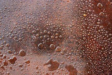 background of water drops on oily surface of iron sheet