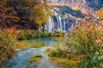 Picturesque morning view of pure water waterfall in Plitvice National Park. Wonderful autumn scene of Croatia, Europe. Abandoned places of Plitvice lakes series. Beauty of nature concept background.