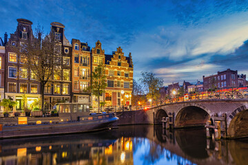 Amsterdam Netherlands, night city skyline of Dutch house at canal waterfront