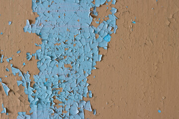 Peeling paint on the wall. Old concrete wall with cracked flaking paint. Weathered rough painted...