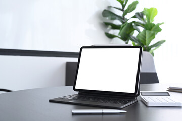 Fototapeta premium Accountant workspace with computer tablet and calculator on black office desk.