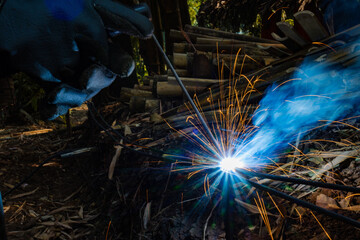 Industrial workers at a close-up welding plant