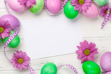 Easter greeting card with colorful easter eggs and flowers