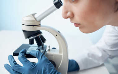 microscope research medical gown woman doctor gloves laboratory