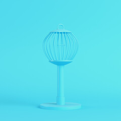 Bird cage on bright blue background in pastel colors