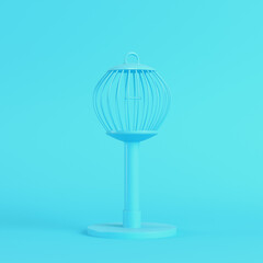 Bird cage on bright blue background in pastel colors