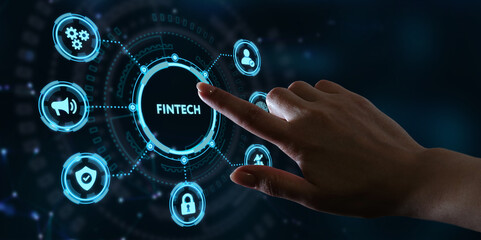 Fototapeta premium Fintech -financial technology concept.Young businessman select the icon Fintech on the virtual display.