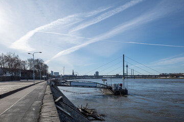 Outdoor sunny view promenade riverside and bridge toward pier, pontoon or buoy over Rhine River and...