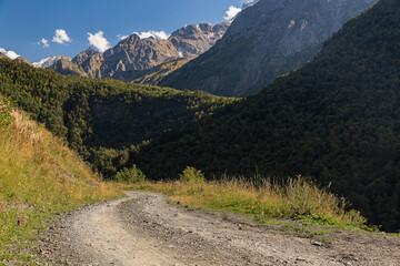 Picturesque mountain landscape with river and peaks on a sunny day. Caucasus Mountains. National Park North Ossetia - Alania