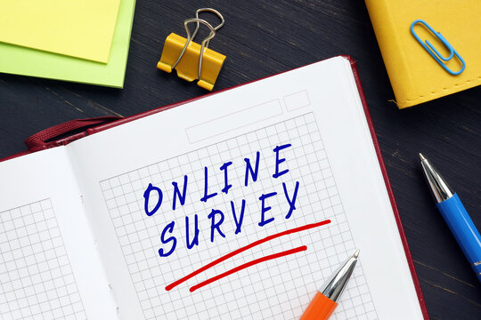 Financial concept about ONLINE SURVEY with phrase on the sheet. An online survey is a structured questionnaire that your target audience completes over the internet generally through