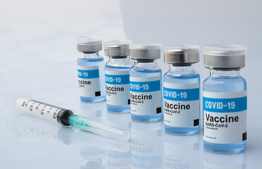 Set of Covid-19 Vaccine bottle blue liquid with syringe on white background