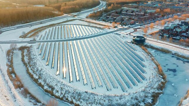 Solar panels farm in a modern sustainable neighbourhood in Almere, The Netherlands, in winter. Aerial shot.