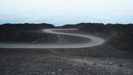 Volcanic ash and stones 4wd road like on the moon concept, Etna volcano, Sicily, Italy