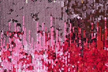 Sequins macro background.Pink, burgundy and purple sequins background. Shiny  surface with...