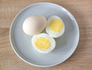 an egg cut in half and a whole egg