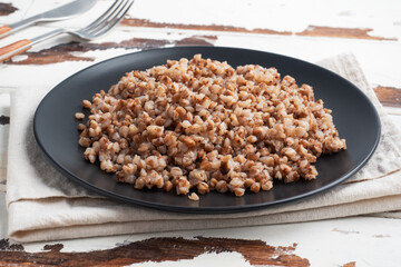 Boiled buckwheat on a plate. Healthy porridge enriched with vitamins. copy space,