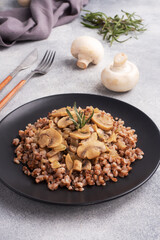 Boiled buckwheat with stewed mushrooms. Russian traditional food. Healthy diet food.