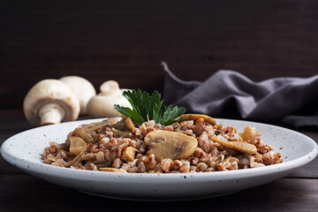 Boiled buckwheat with stewed mushrooms. Russian traditional food. Healthy diet food.