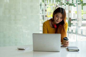 Asian business women chatting with colleagues about videoconferencing plans, online learning, work from home concept.