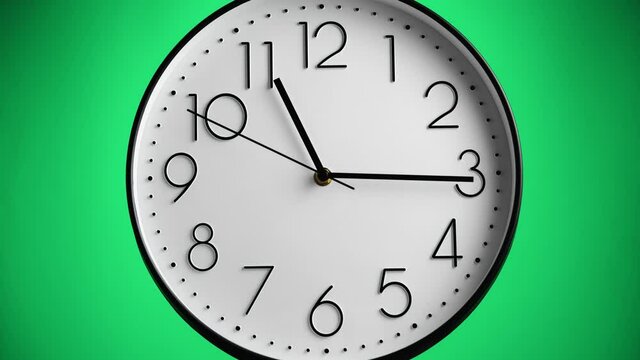 White wall clock on green background. One hour to 12, time-lapse. Time concept.