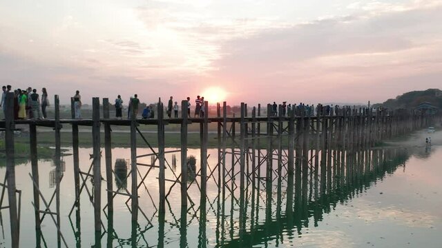 Aerial of famous wooden U Bein Bridge with red sunset in Myanmar