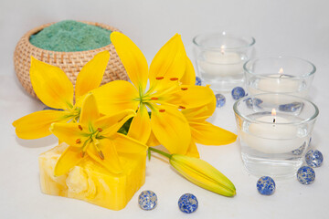 soap with natural ingredients , flowers and candle in glass