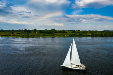Yacht sailing at sunset. Luxury vacation at sea.
