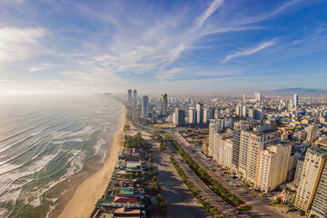 Beautiful My Khe beach from drone in Da Nang, Vietnam, street and buildings near the Central beach...