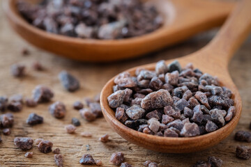 Himalayan black rock salt on wooden spoon