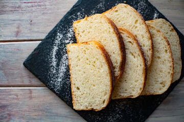 sliced bread on iron plate on wooden table