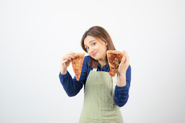 Shot of female cook in apron holding pizza on white background