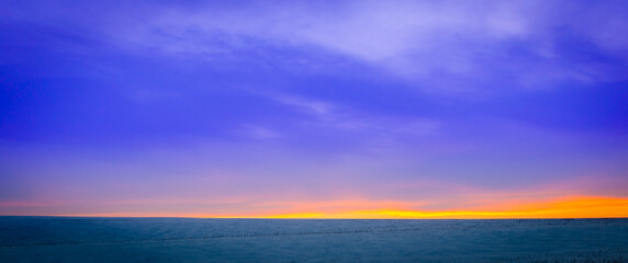 Naklejka na ściany i meble Beautiful blue sunset in the winter season.
