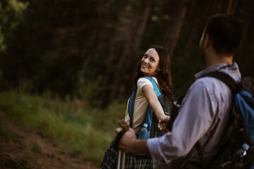 Fototapeta premium Happy couple is hiking in forest.
