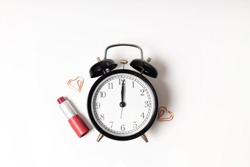 Watch and lipstick on white background