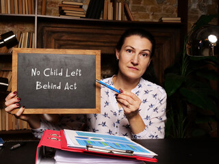 Hand holding chalkboard with phrase No Child Left Behind Act .