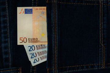 money in your pocket. euro bills of different denominations in the back pocket of jeans. The...
