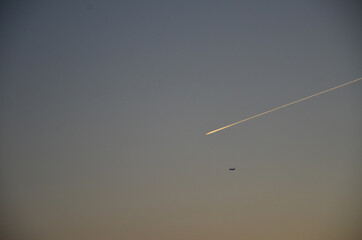 Blue sky and clouds with jet trail.