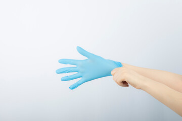 Female doctor wearing medical gloves for protective epidemic Corona Virus
