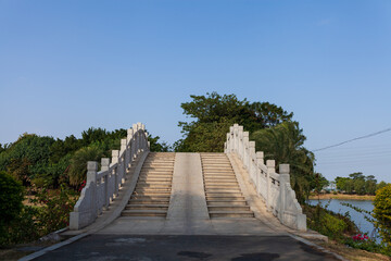 Fototapeta na wymiar Chinese style stone bridge under blue sky