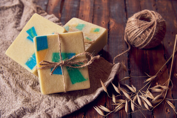 A fragrant organic handmade soap with a geometric pattern , a linen napkin and a few dry spikelets .