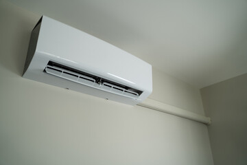 Air conditioner inside top the room man operating remote controller open air conditioner energy savings