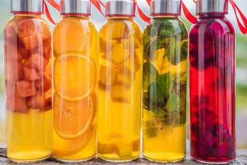 Cambucha with various fruits arranged in the form of a rainbow. Homemade fermented raw kombucha tea with different flavorings. Healthy natural probiotic flavored drink. LGBT