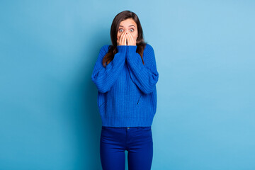 Photo of young shocked amazed terrified scared afraid girl cover mouth with hands isolated on blue...