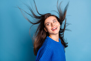 Photo of young beautiful smiling cheerful positive girl look copyspace with flying hair isolated on...