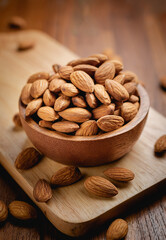 Almonds seed in the wooden bowl on the wooden table.